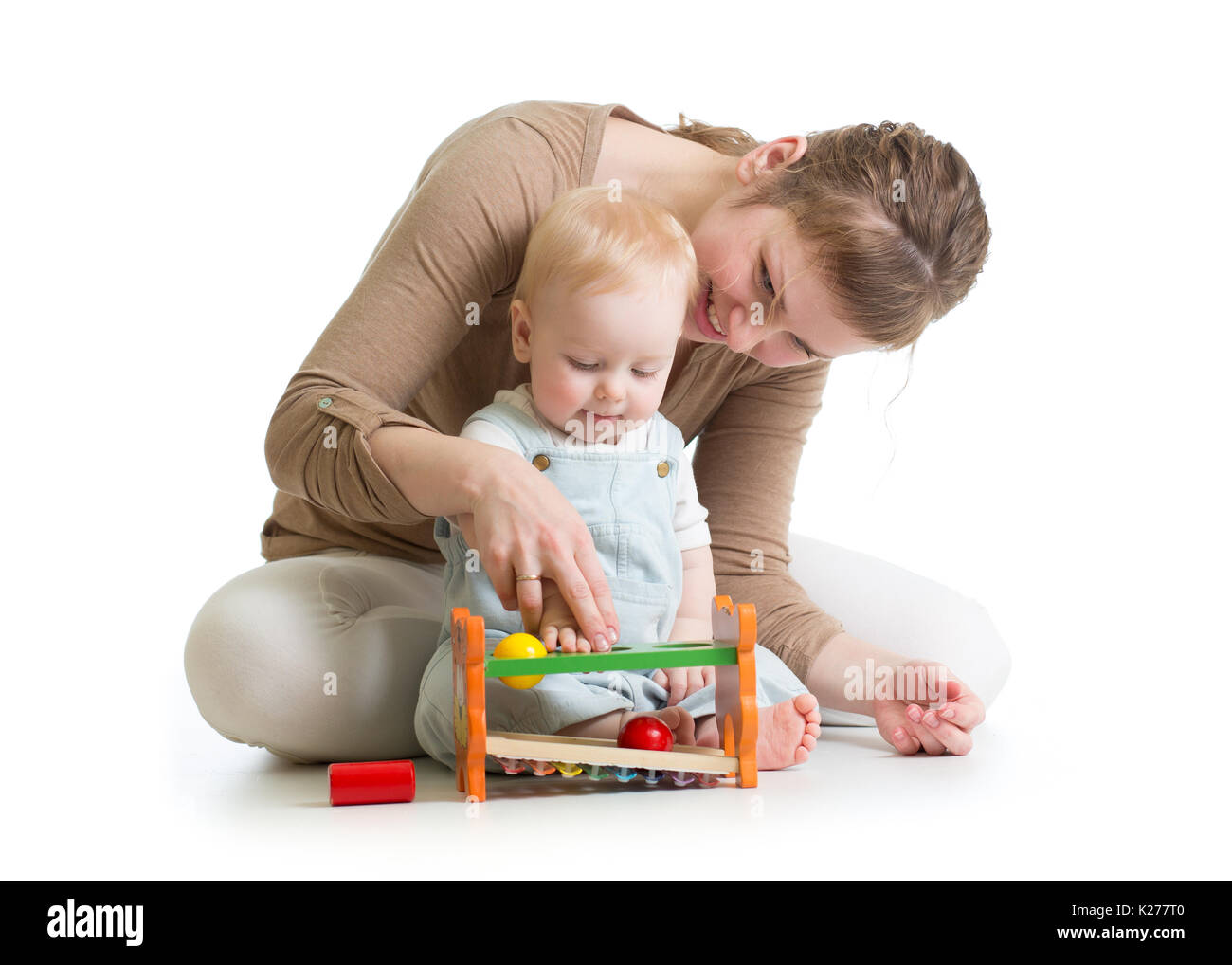 baby boy and mother playing together with logical toy Stock Photo