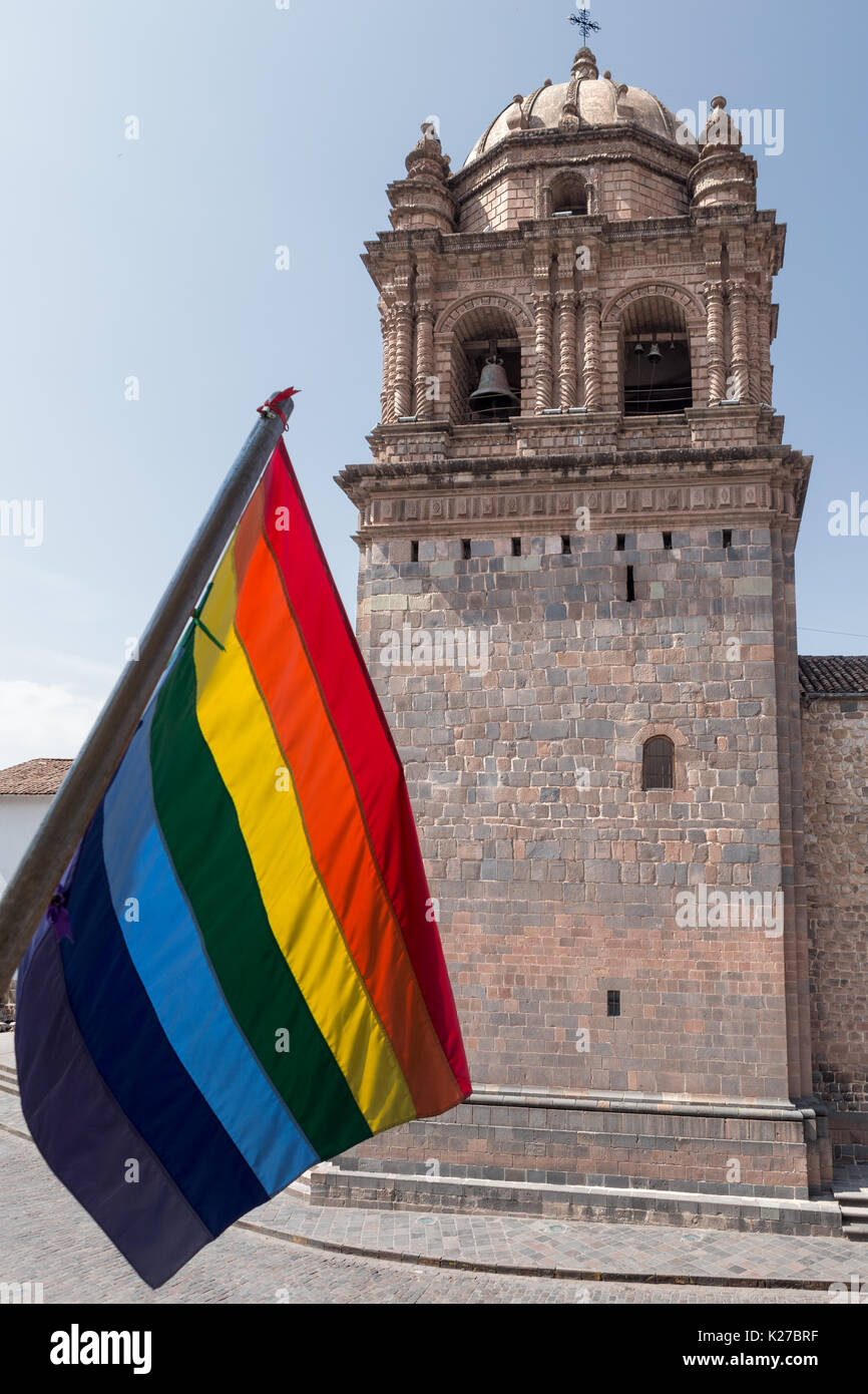 Santo Domingo Church tower Cusco + Official rainbow flag of Cusco (flag of Tawantinsuyo to commemorate the Inca Empire) Peru Stock Photo