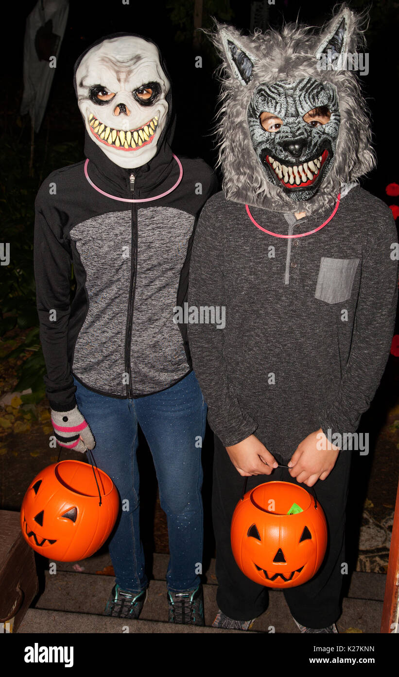 Friendly teen ghoul and wolf in costume out for a night of Halloween trick or treats. St Paul Minnesota MN USA Stock Photo