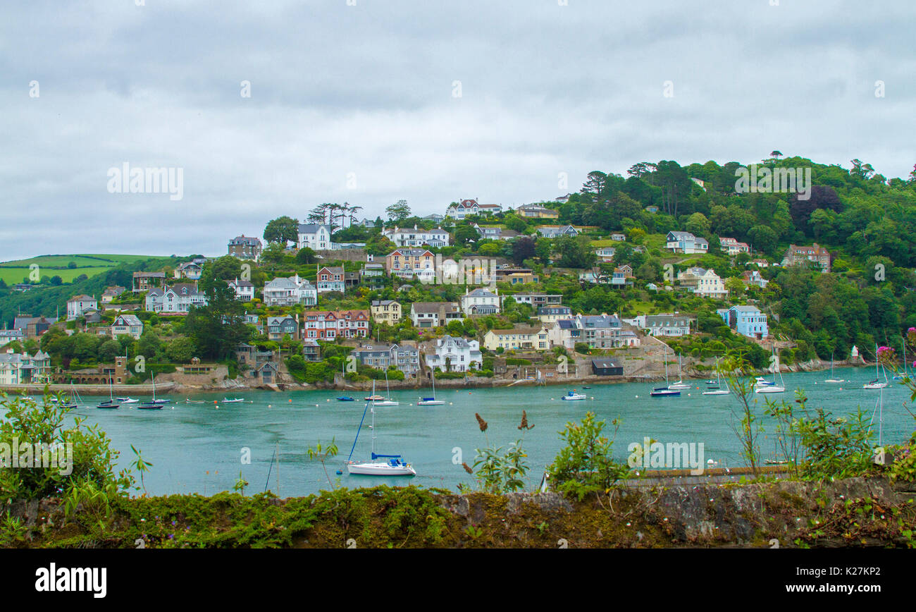 Coastal town of Dartmouth with houses crammed on treecloaked hillside