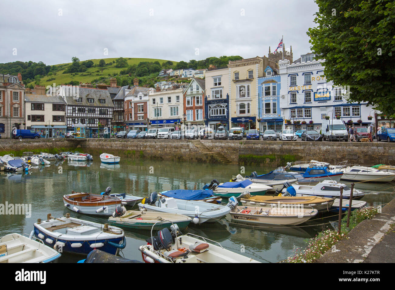 English coastal town of Dartmouth with elegant historic buildings bordering harbour with boats in calm water, Devon UK Stock Photo