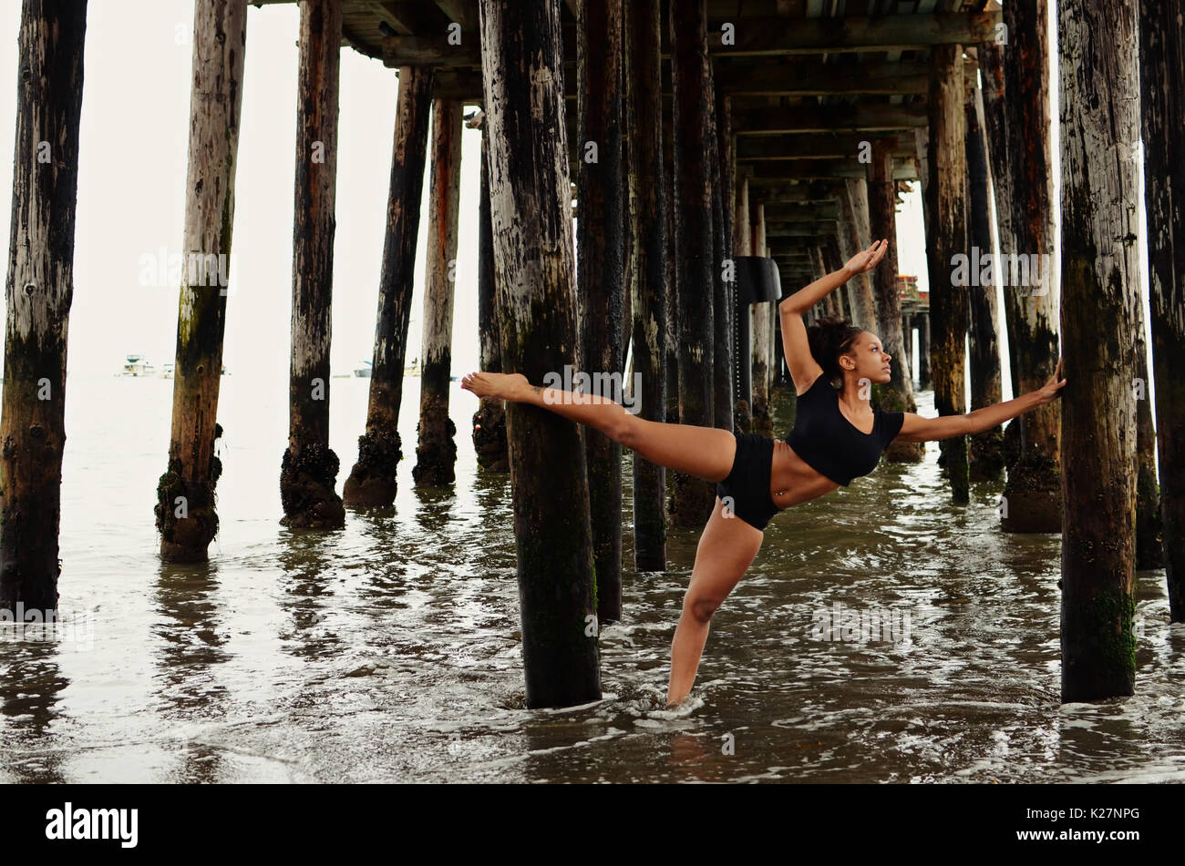 Lyrical dancer under pier Stock Photo