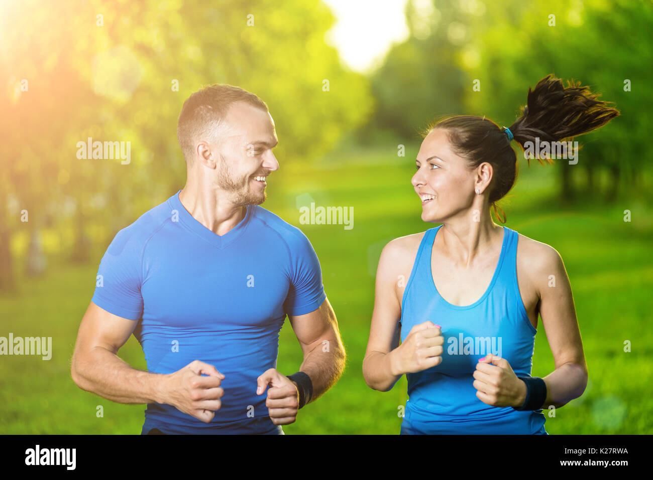 Runners training outdoors working out. City running couple jogging outside.  Stock Photo