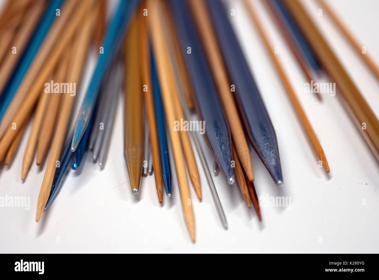 Collection of knitting needles on a white background Stock Photo - Alamy