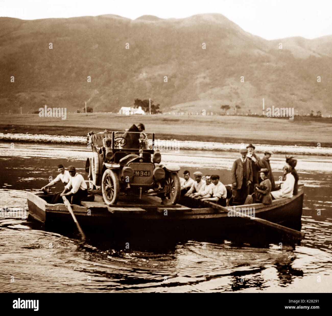 A veteran car on a rowing boat ferry, early 1900s Stock Photo