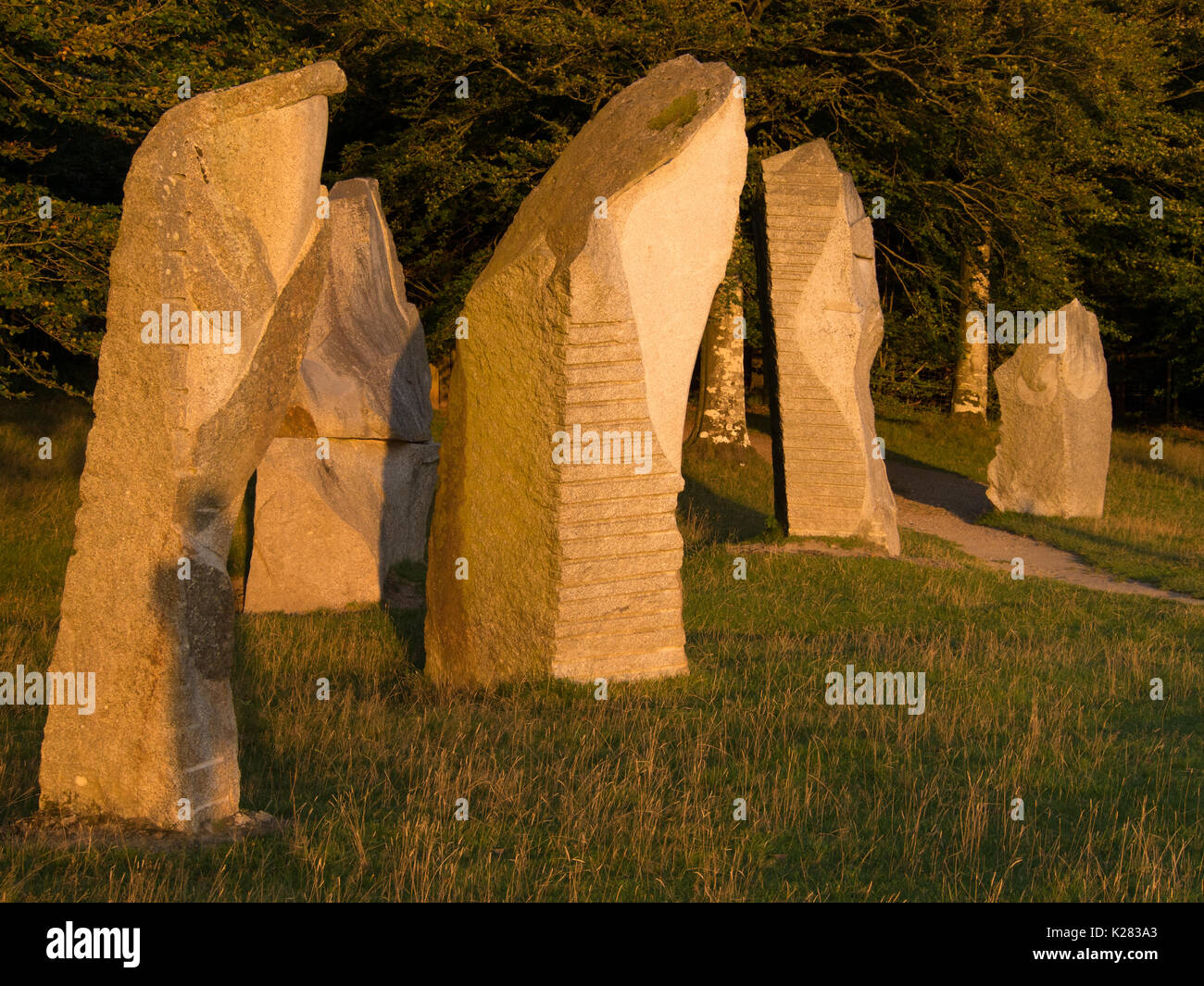 The stones lit by the setting sun at Heaven's Gate, Longleat, Wiltshire, at the end of a hot August Bank Holiday Stock Photo