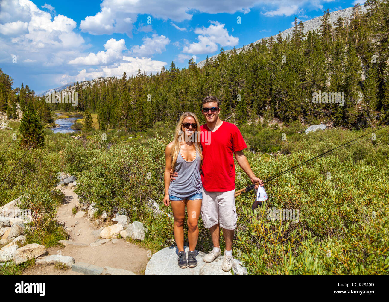 Couple with fishing gear by trail at Little Lakes Valley in Rock Creek Canyon in the Eastern Sierra Nevada in Northern California Stock Photo