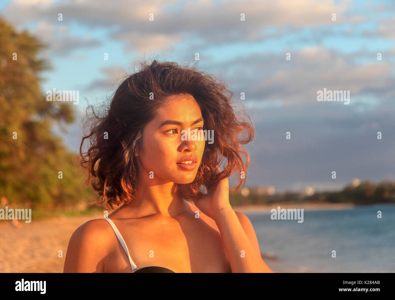 Woman at Kahekili Beach in Kaanapali, Maui at sunset Stock Photo