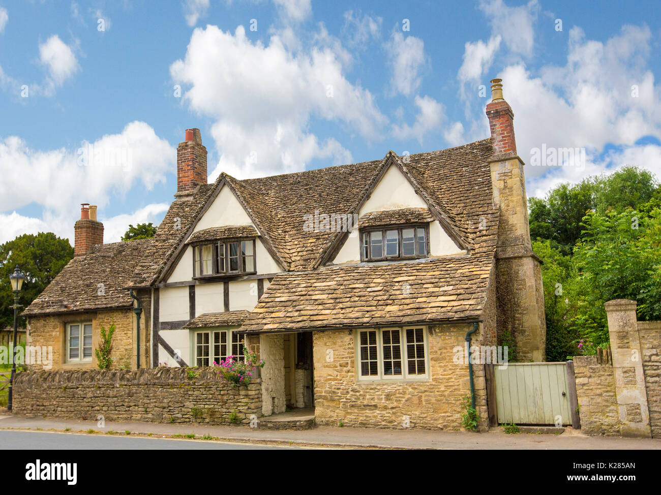 Historic house under blue sky in village of Lacock, Wiltshire, England Stock Photo