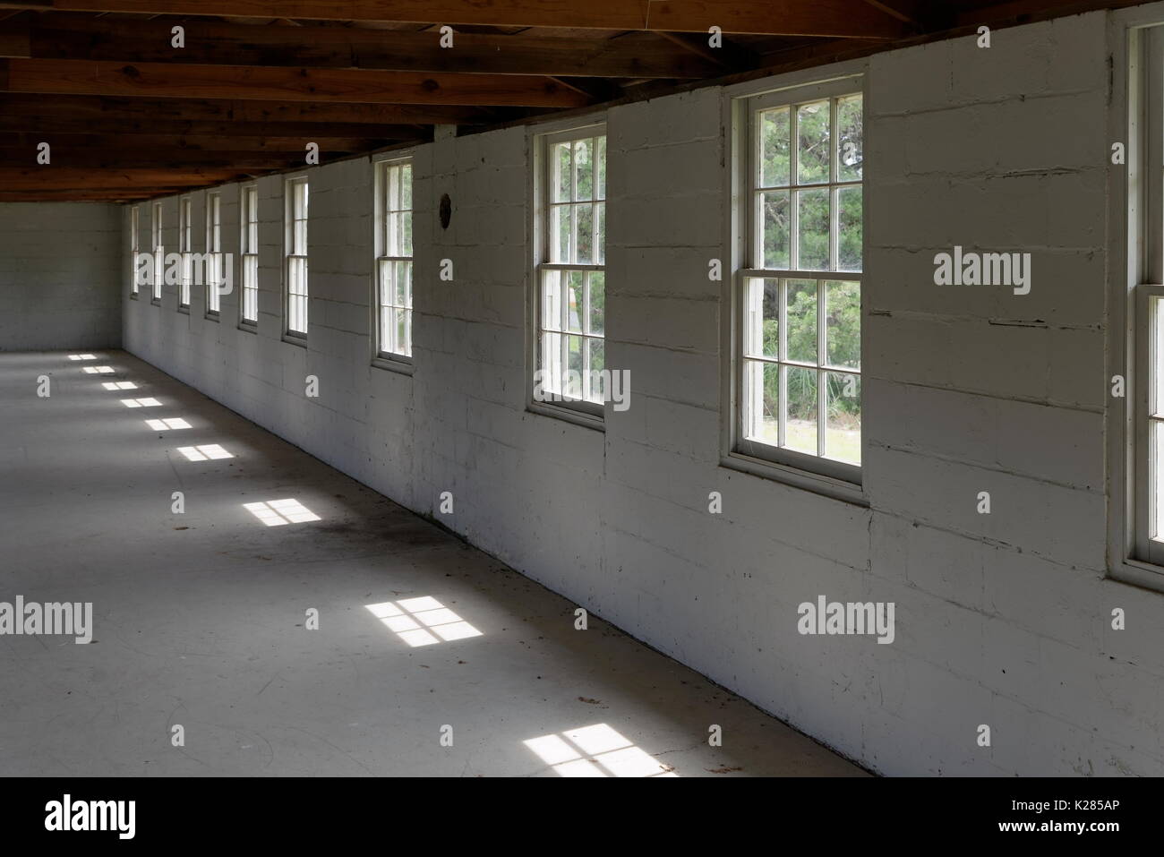 Empty WW2 Army Barracks with window light, Fort Miles, Delaware, USA Stock Photo