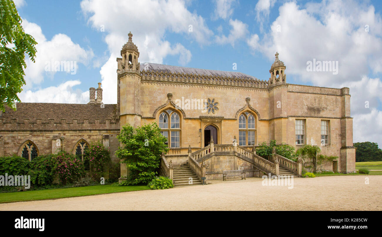 Panoramic view of historic 13th century Lacock abbey in village of Lacock, Wiltshire, England under blue sky Stock Photo