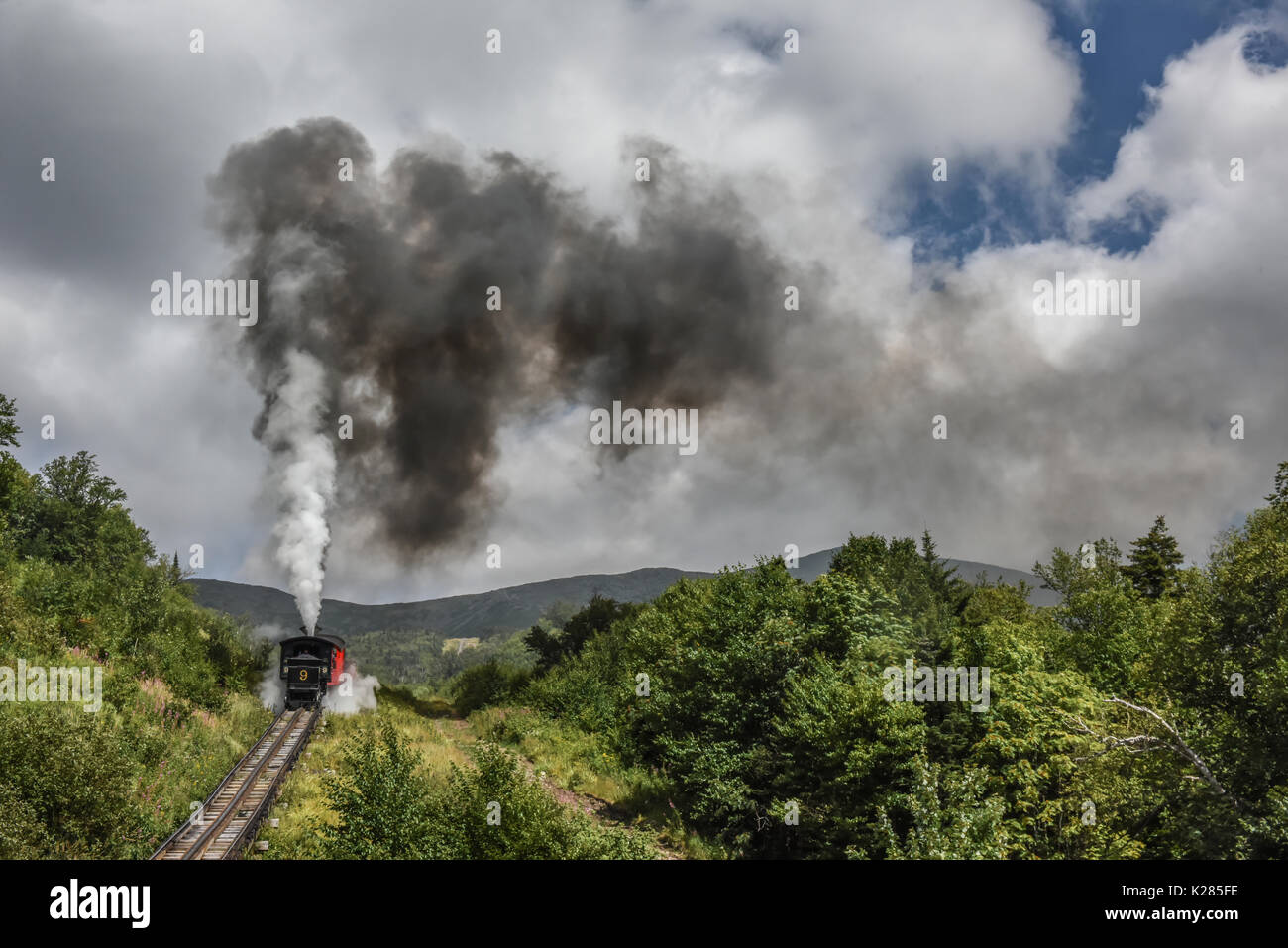 Steam engine - cog railway - powers its way up Mount Washington in New Hampshire United States - White Mountain National Forest Stock Photo