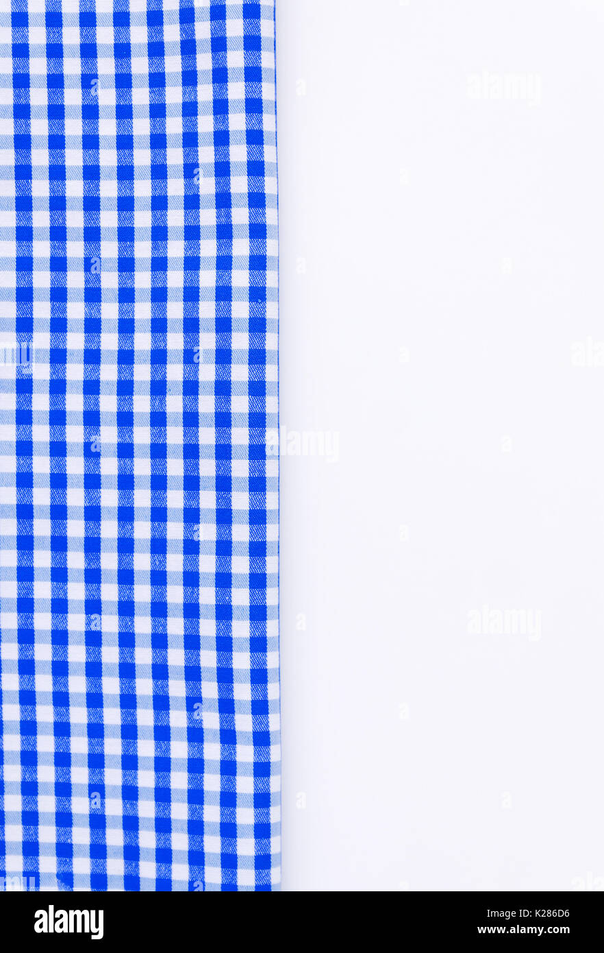 Blue cloth, a kitchen towel with a checkered pattern, on a white background isolated. Stock Photo