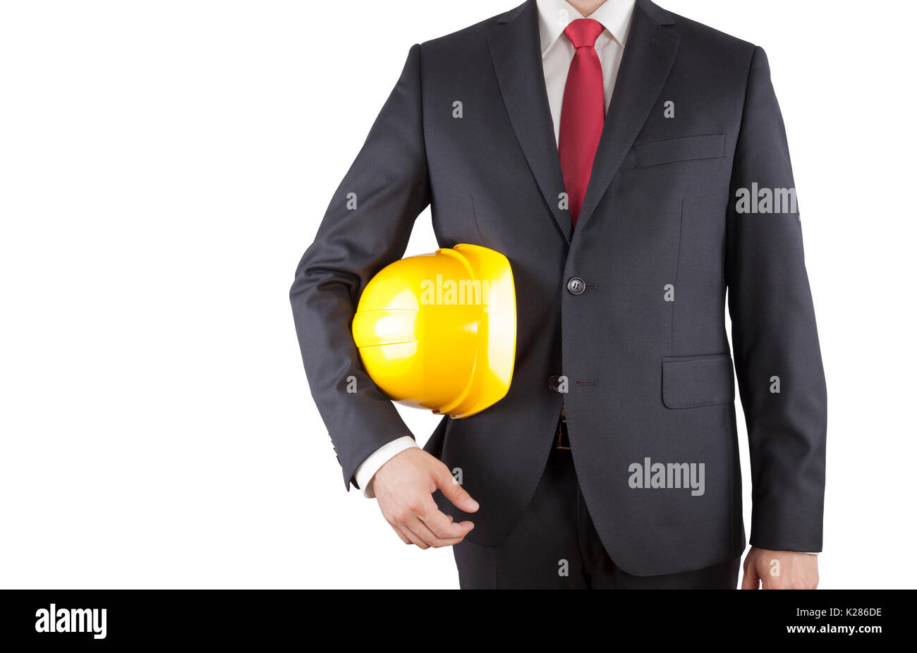 Engineer in black suit holding yellow helmet isolated on white with clipping path Stock Photo