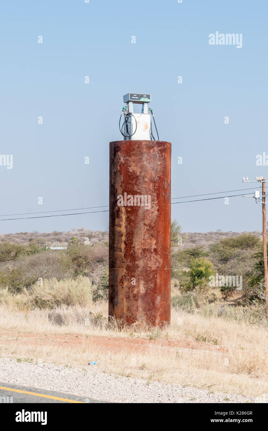 An old fuel storage tank and gas pump marks the northern entrance to Kamanjab, a small town in the Kunene Region of Namibia Stock Photo