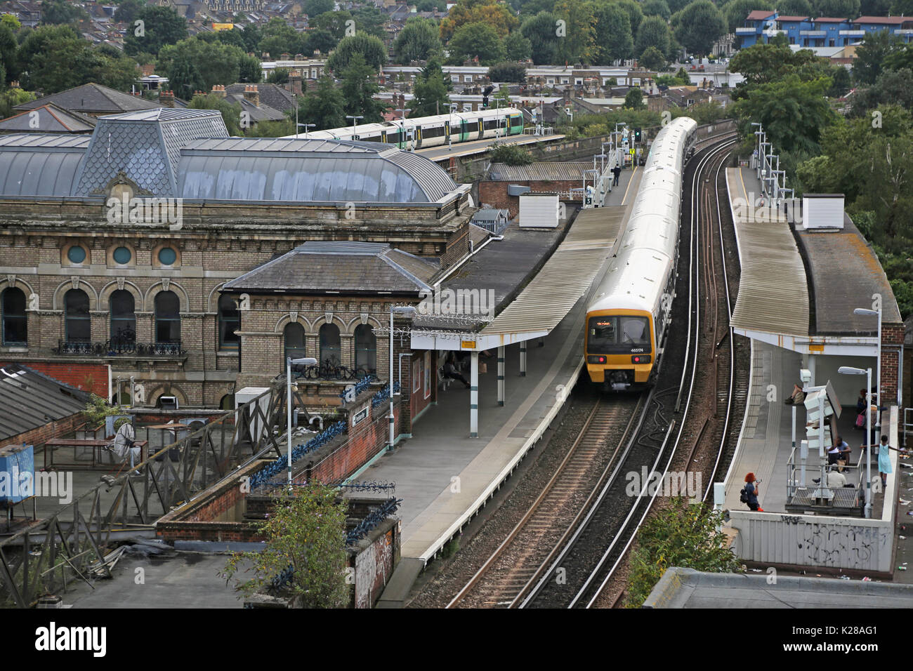 High level view of Peckham Rye Station in Southeast London, UK. Shows Southeastern network train at Platform 3 and the Victorian station building. Stock Photo