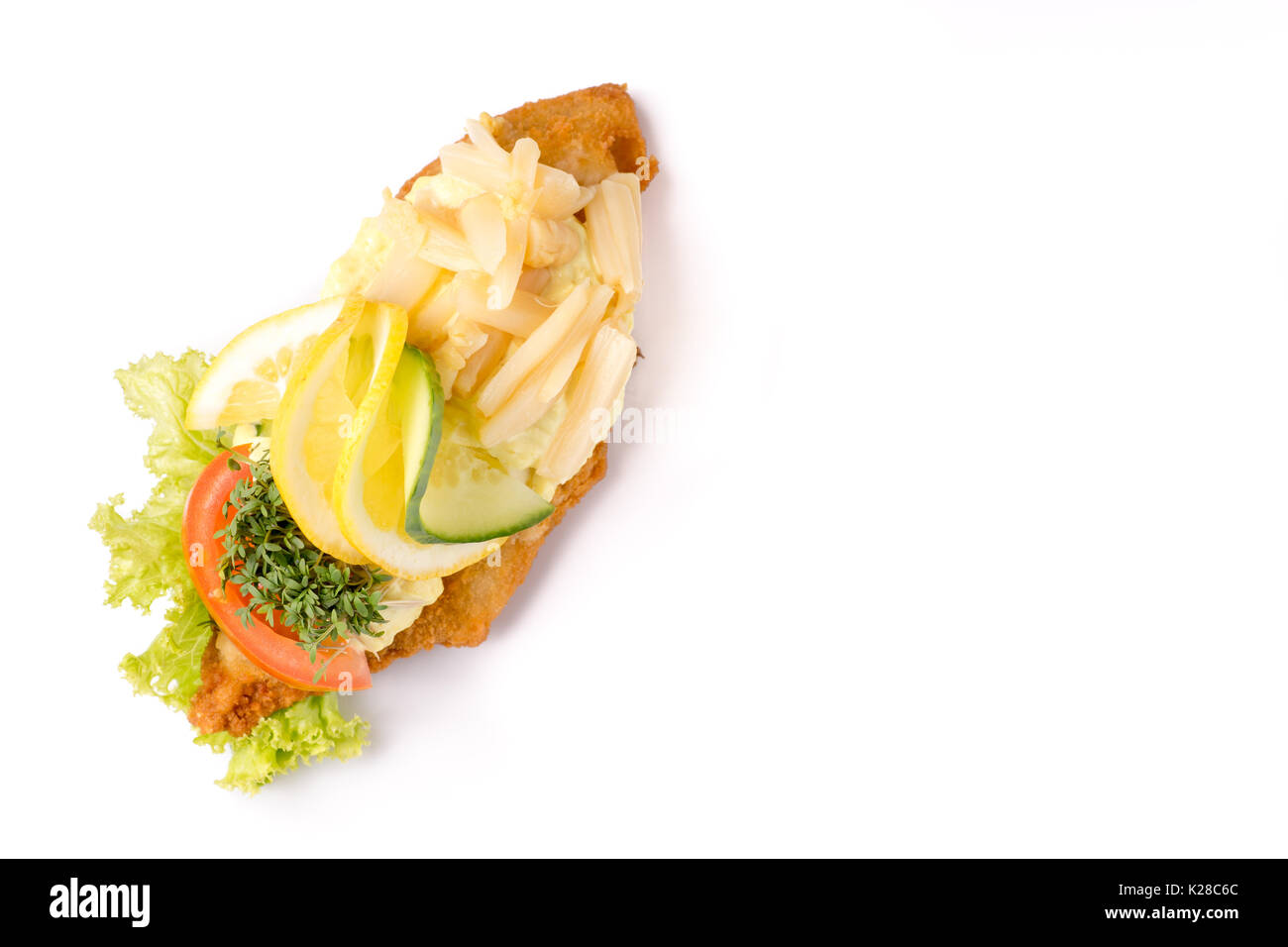 Danish specialties and national dishes, high-quality open sandwich, isolated on white background. fish fillet and garnished with remoulade and lemon Stock Photo