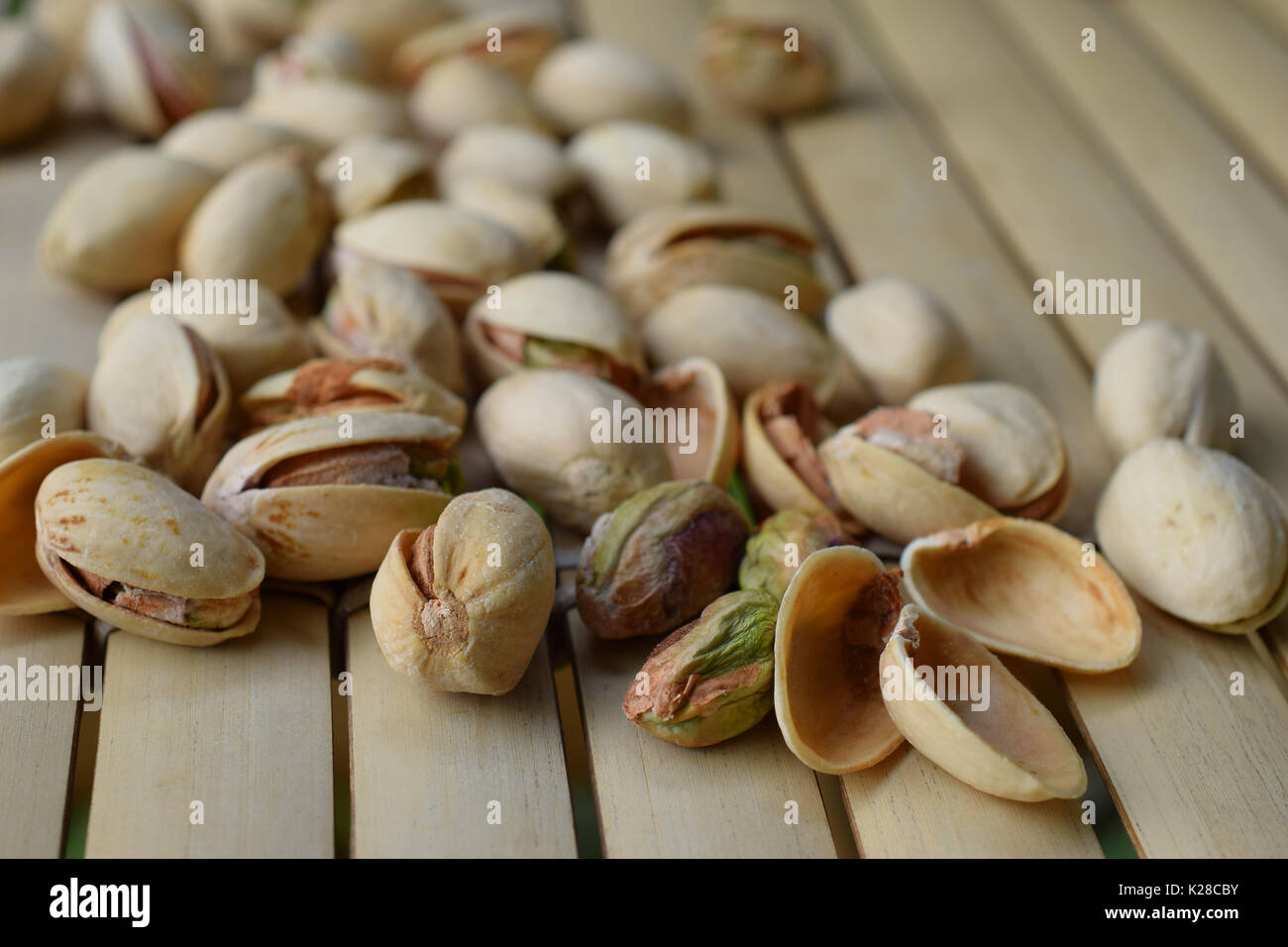 Pistachio nuts on bamboo table. Horizontal image. Stock Photo