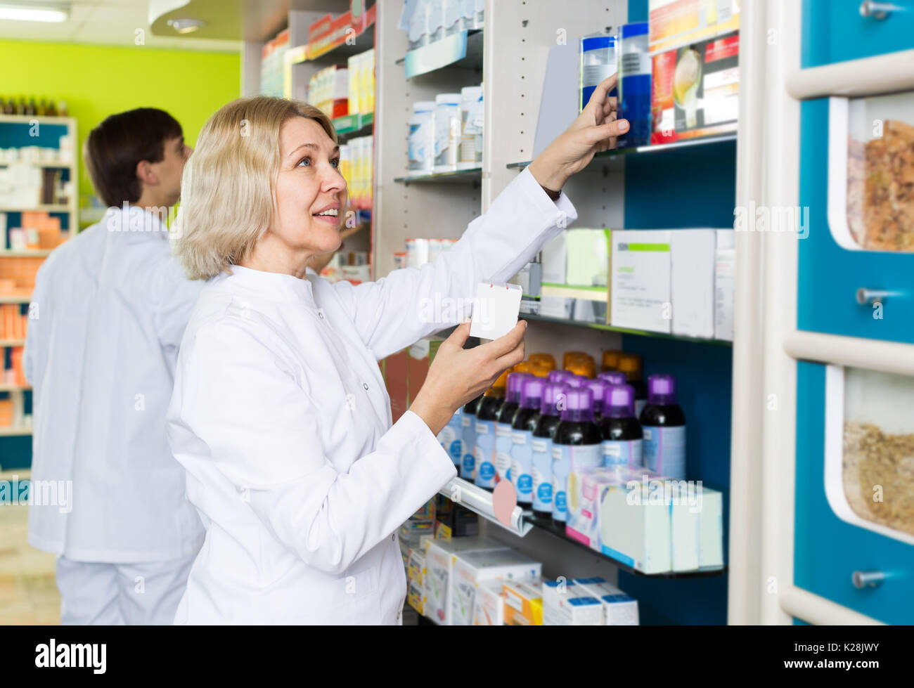 Team of pharmaceutist and technician posing in chemist shop Stock Photo