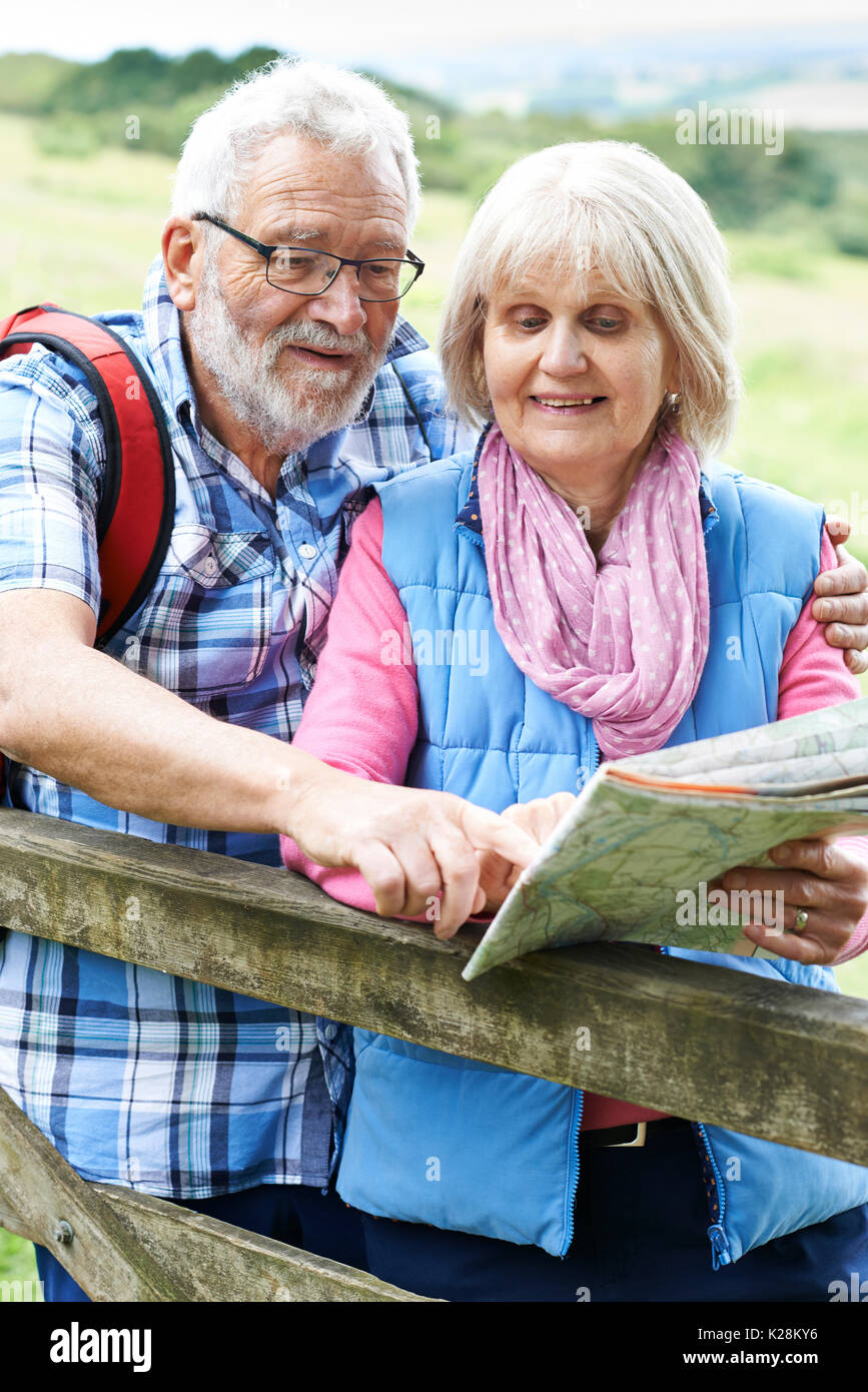 Senior Couple Hiking In Countryside With Map Stock Photo