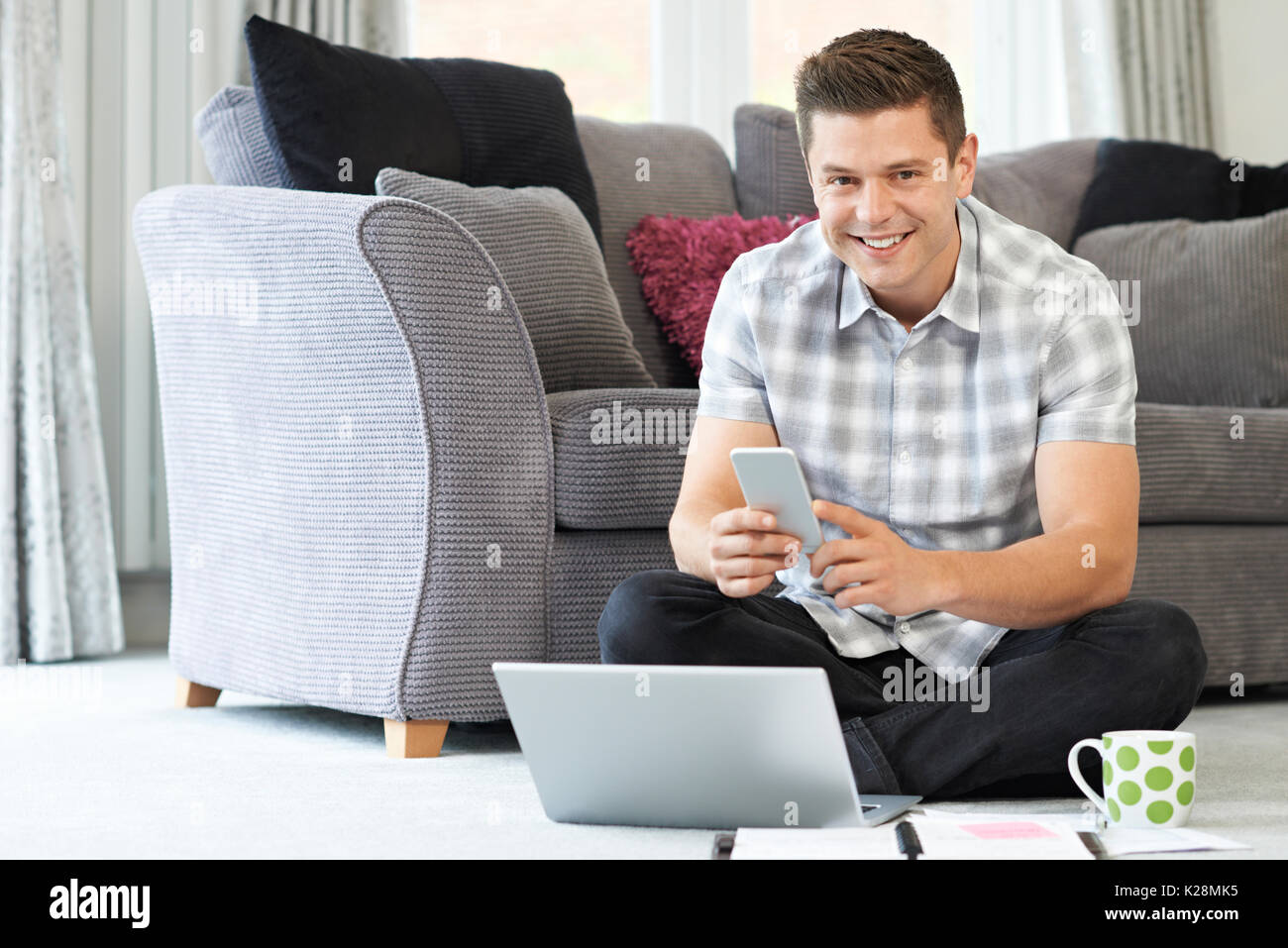 Male Freelance Worker Using Laptop At Home Stock Photo