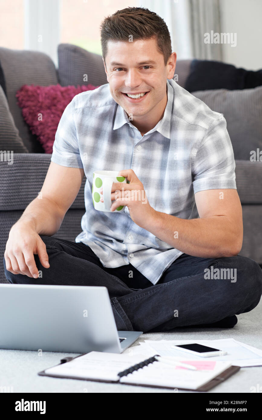 Male Freelance Worker Using Laptop At Home Stock Photo