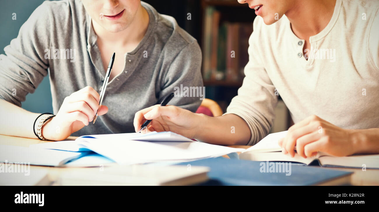 Handsome student working on an essay Stock Photo