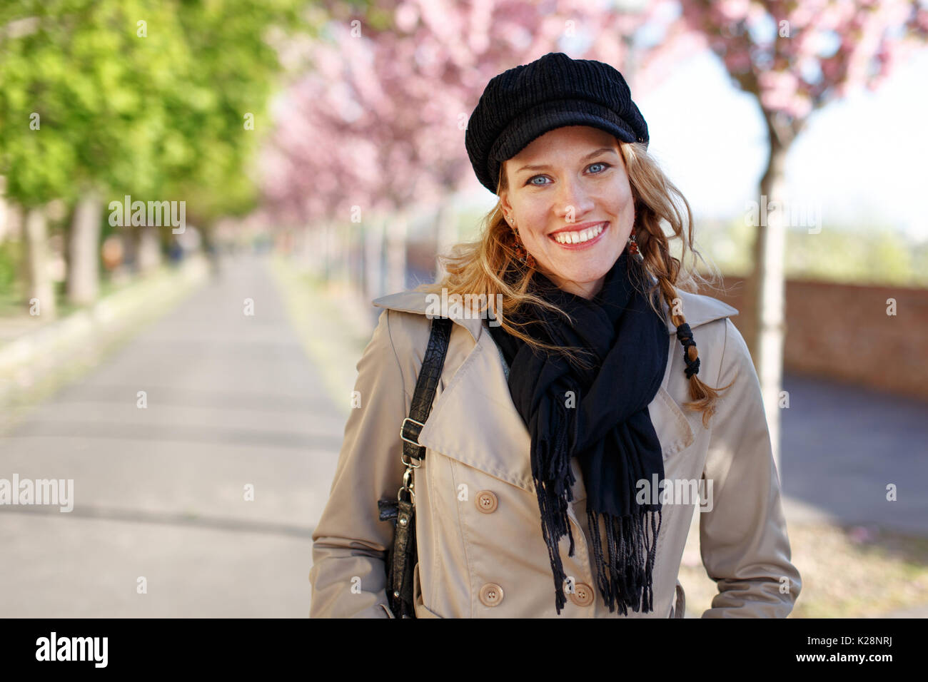 Happy young woman toothy smile at early spring in park Stock Photo - Alamy