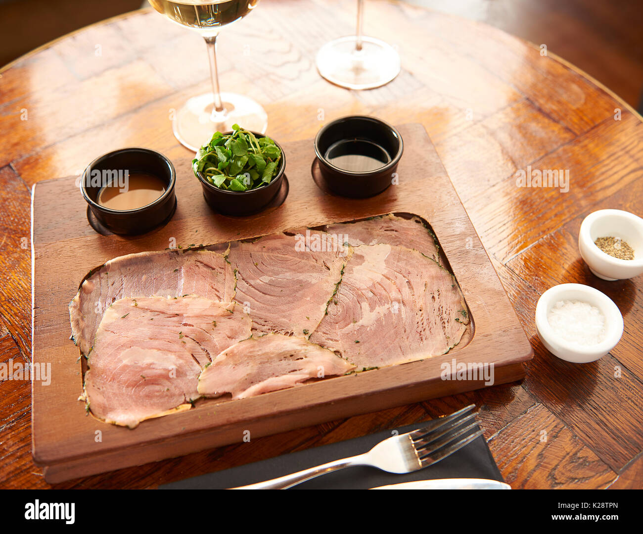 thin sliced tuna starters and wine Stock Photo