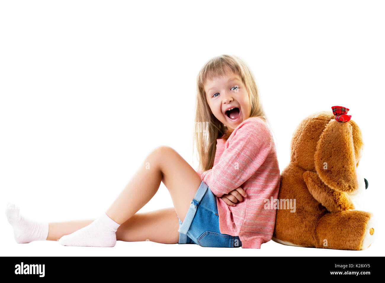 Cute little girl with a big teddy bear sitting on the floor. Isolated ...