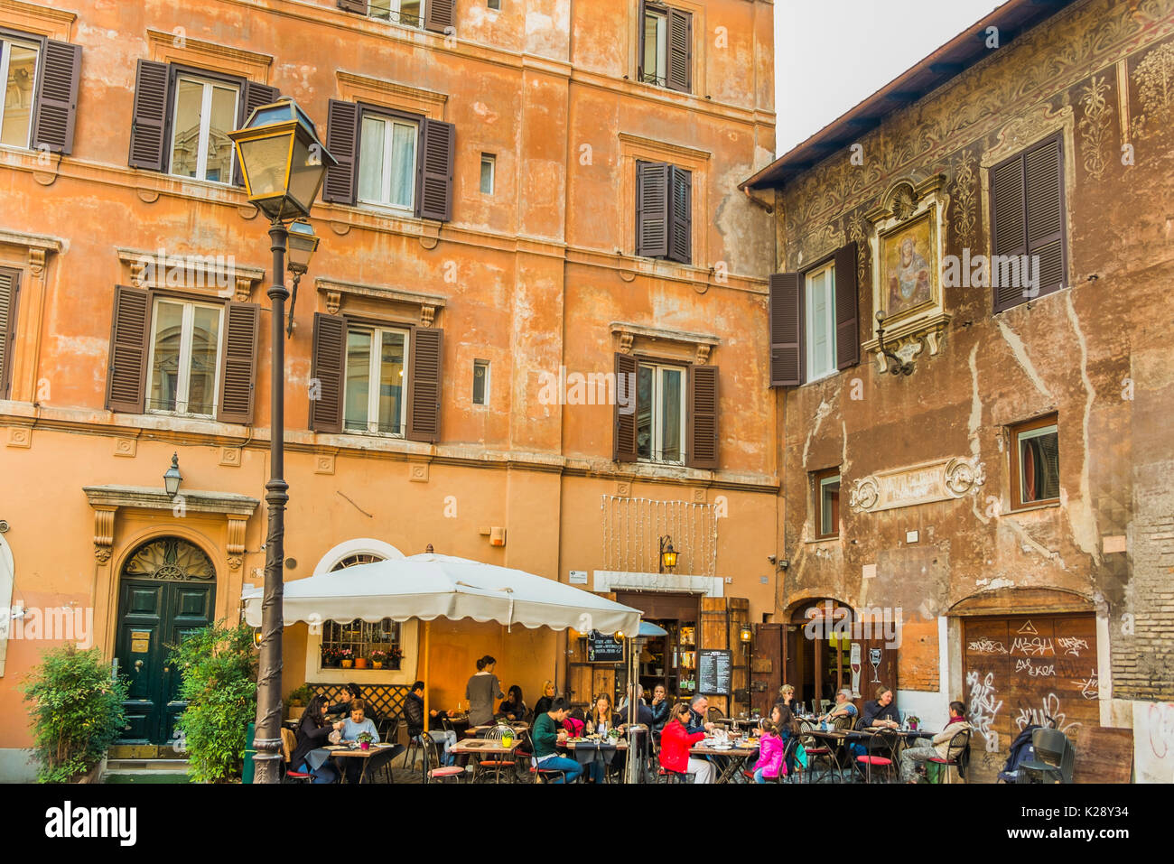 tourists and romans having lunch in front historic facade in the historic city center of rome Stock Photo