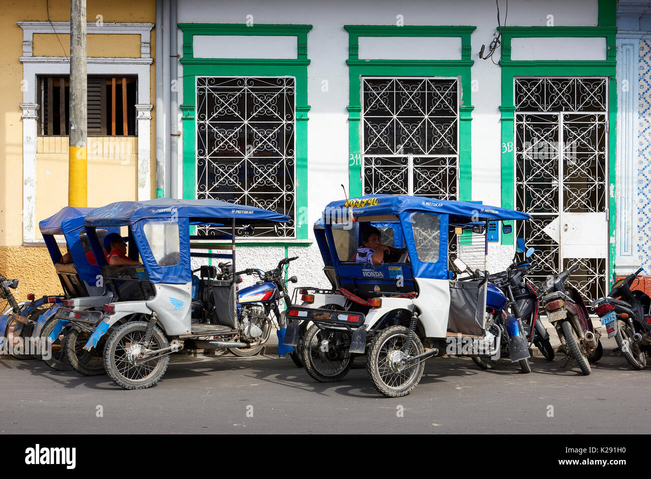 Mototaxi drivers taking a break in the shade in Iquitos, Peru. Stock Photo