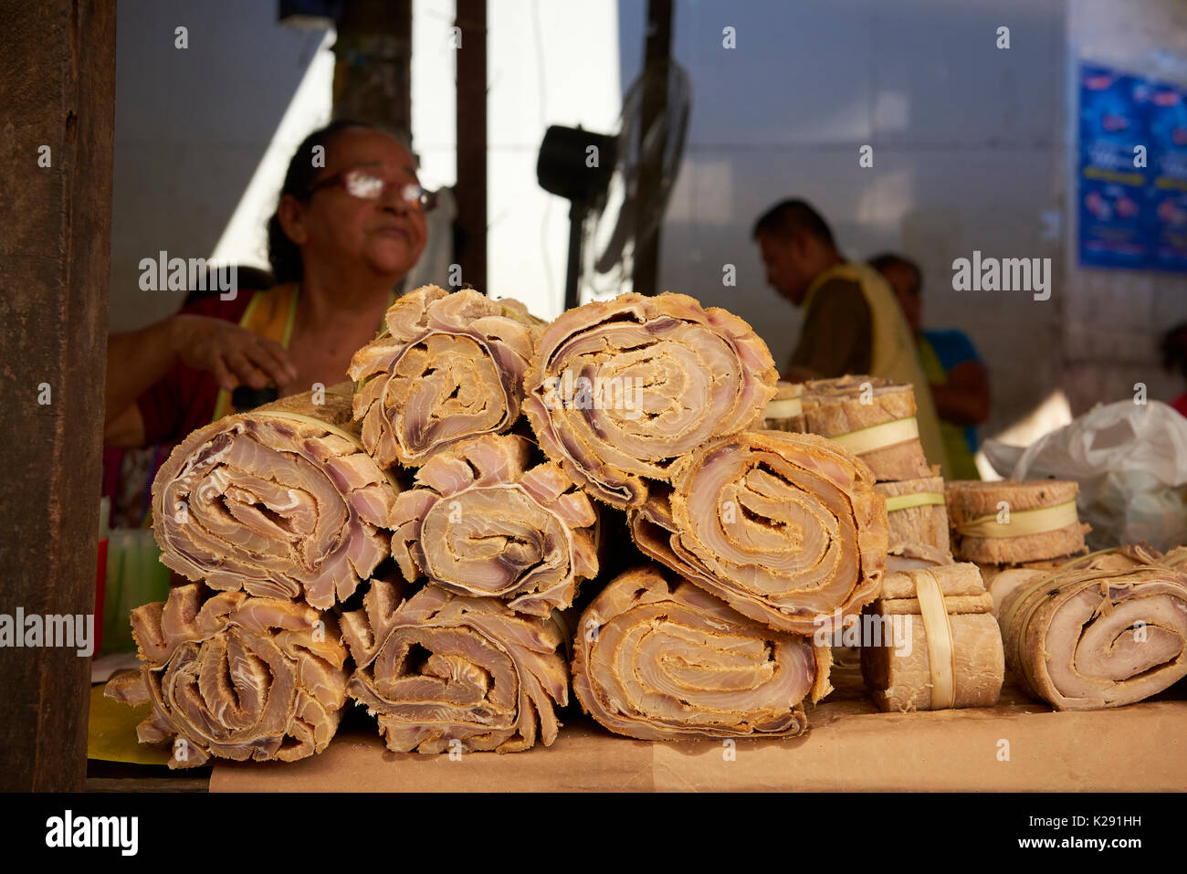 Paiche meat stall in Belem Market, Iquitos, Peru. Paiche, also known as Pirarucu, is one of the largest freshwater fish in the world. Stock Photo