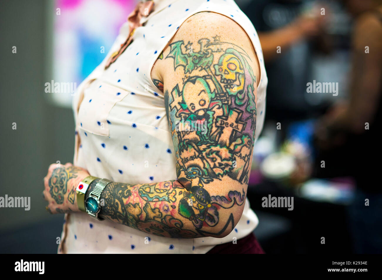 Cornwall Tattoo Convention - the heavily tattooed arm of the tattooist Julia Seizure at the Cornwall Tattoo Convention. Stock Photo