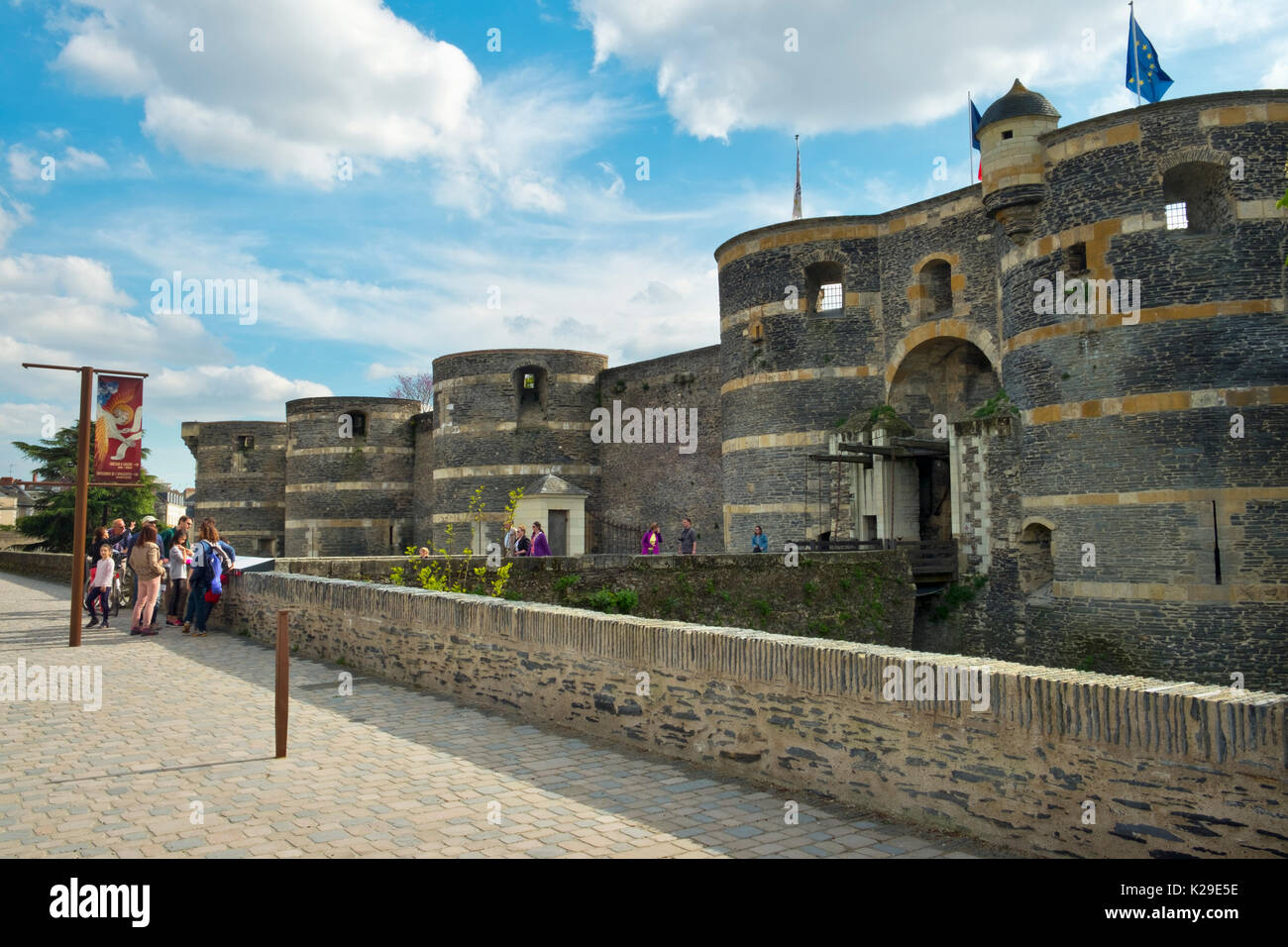 Visitors to the Chateau d'Angers gather at the entrance on a sunny spring afternoon in Angers, Maine-et-Loire, France Stock Photo