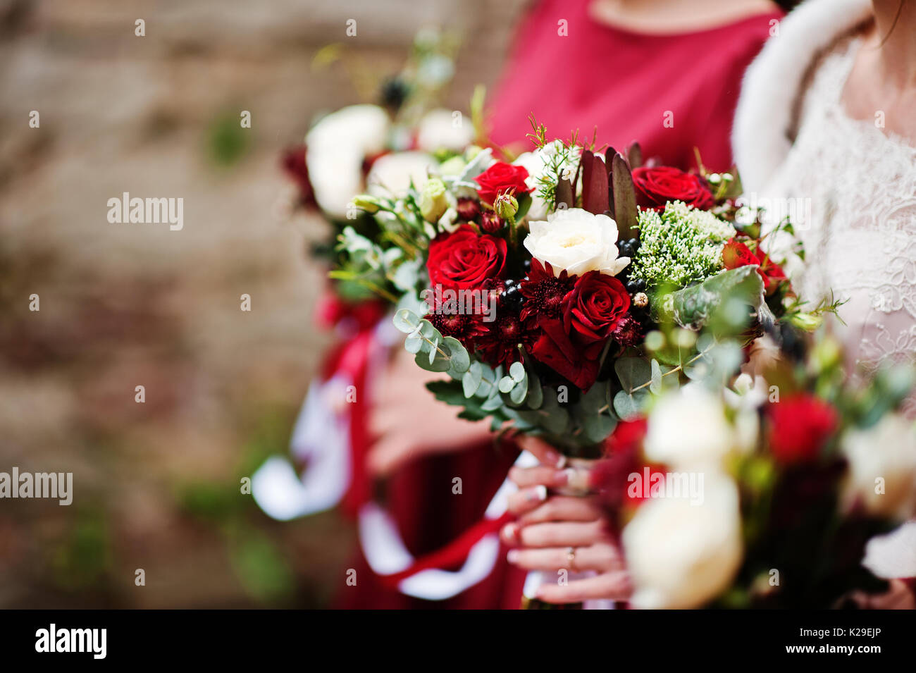 Close-up photo of bridesmaids and bride holding bouquets in their hands ...