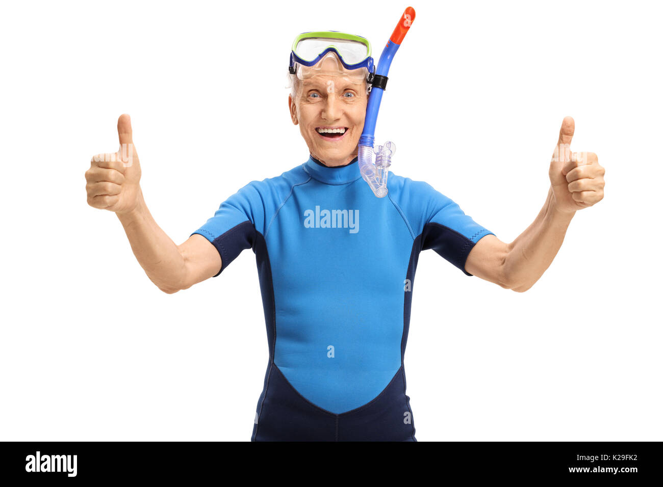 Cheerful senior with snorkeling equipment wearing a wetsuit and making thumbs up sign isolated on white background Stock Photo