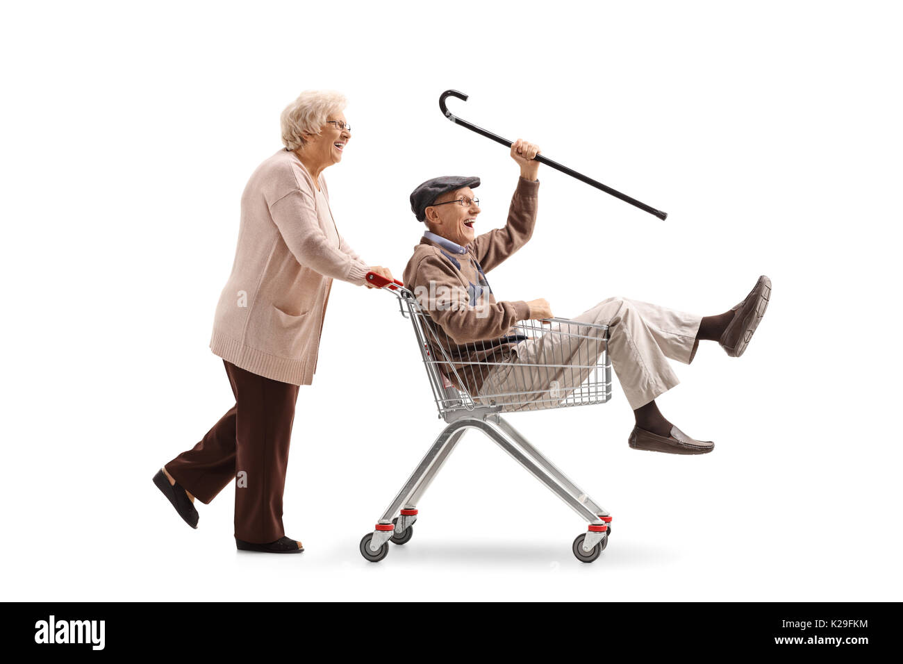 Elderly woman pushing a shopping cart with a senior riding inside it