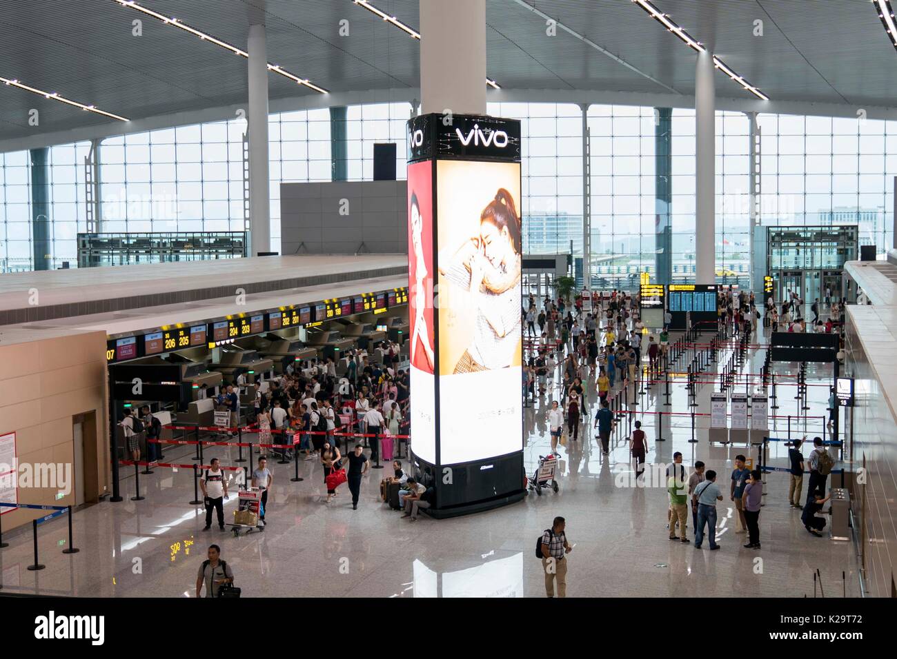 Chongqing, China. 29th Aug, 2017. Passengers check in at the T3A
