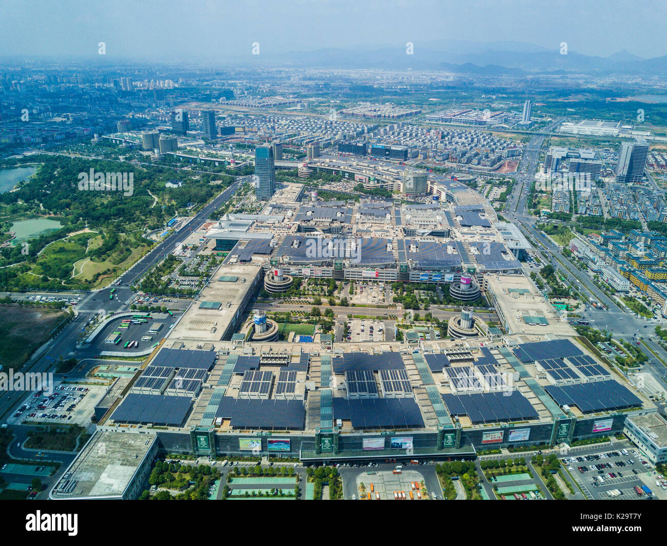 Yiwu. 29th Aug, 2017. Aerial photo taken on Aug. 29, 2017 shows the solar PV panels installed on the roof of Yiwu International Trade City in Yiwu, east China's Zhejiang Province. The PV project on the roof, which has the total installed capacity of 20 megawatt (MW), is planned to supply power to the trade center for the following 25 years. Credit: Xu Yu/Xinhua/Alamy Live News Stock Photo