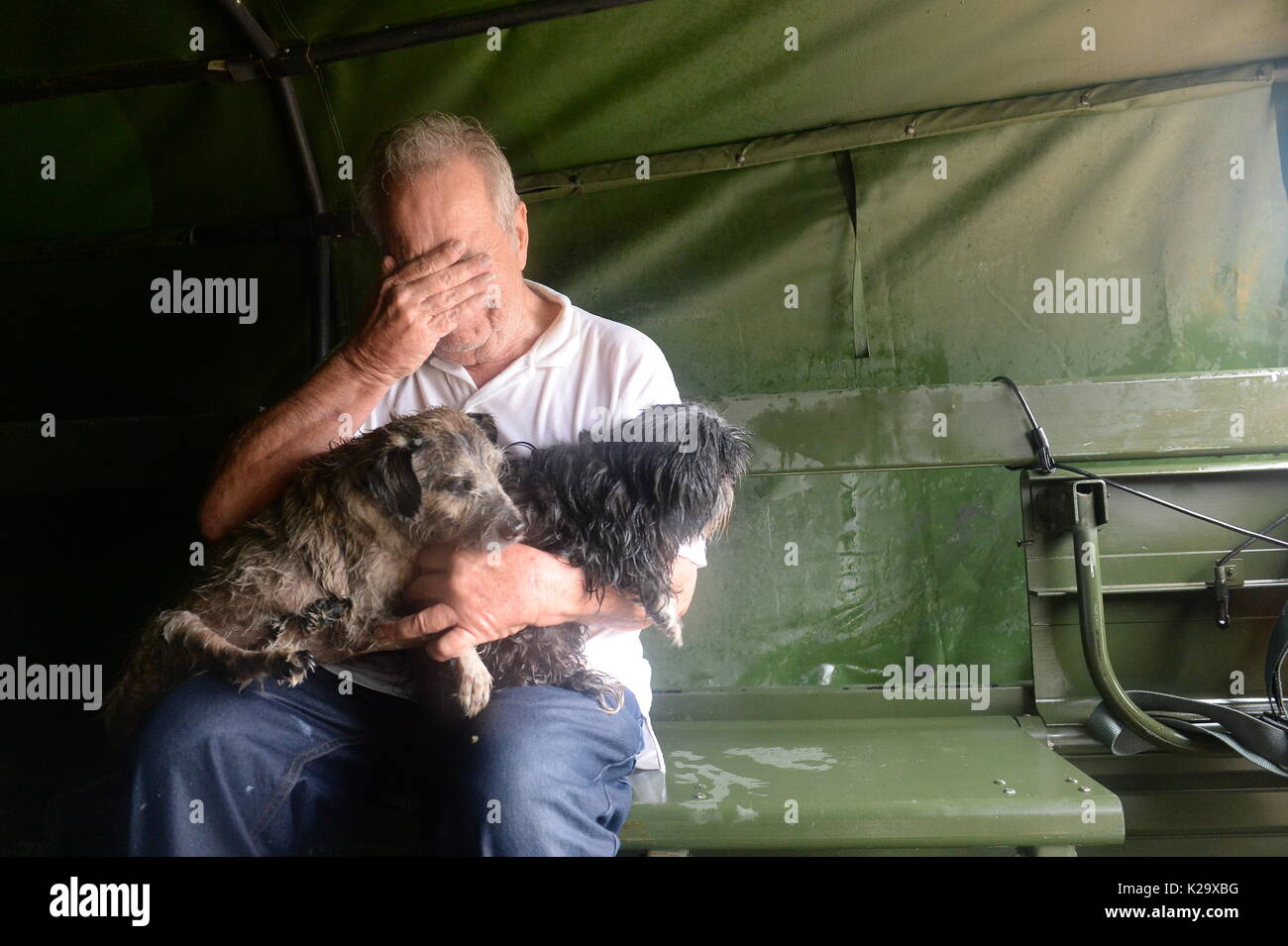 Texas, USA. 28th Aug, 2017. A resident is overcome with emotion after being rescued by Texas National Guardsmen and volunteer fire and rescue personnel from flooding in the aftermath of Hurricane Harvey August 28, 2017 in Cypress, Texas. Credit: Planetpix/Alamy Live News Stock Photo