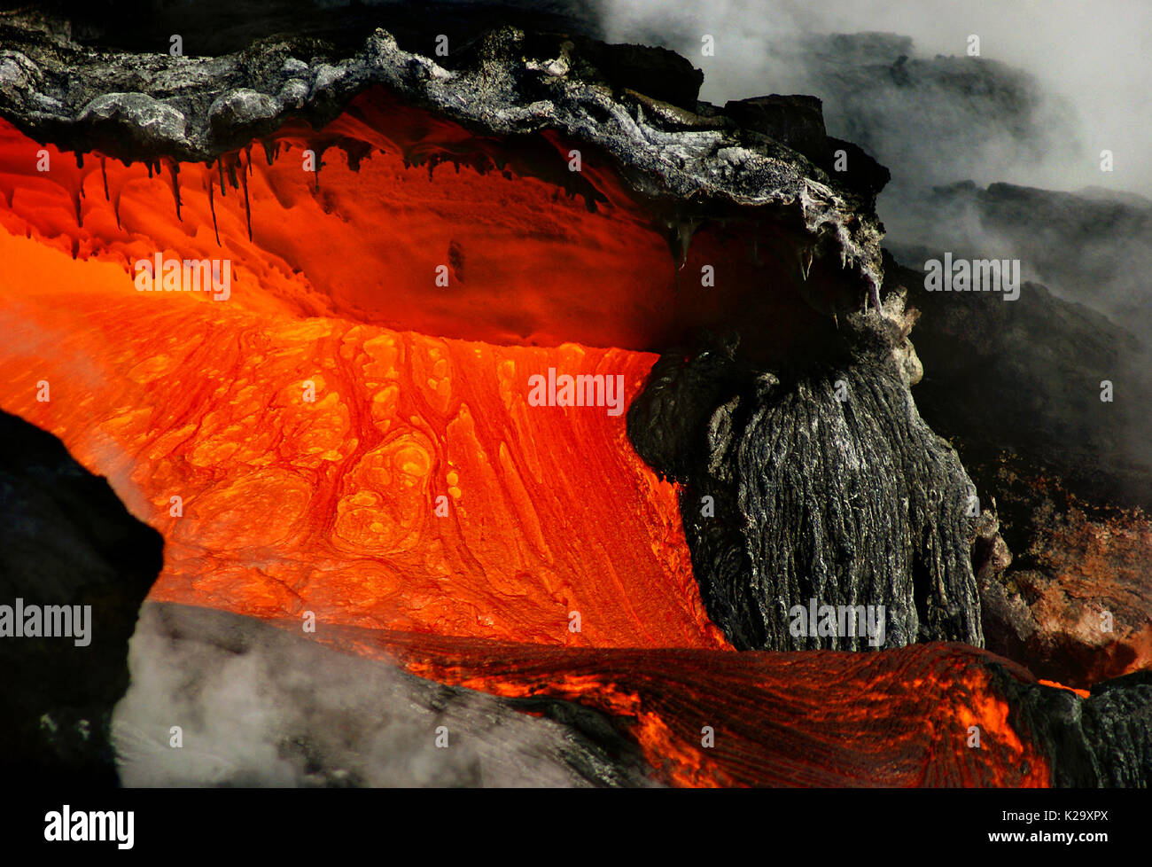 Big Island, Hawaii, USA. 4th Mar, 2007. Molten lava from the Kilauea Volcano forms a cavern as it nears the Pacific Ocean, the extreme temperature difference causing dramatic reactions about Kalapana, Hawaii. Credit: L.E. Baskow/ZUMA Wire/Alamy Live News Stock Photo