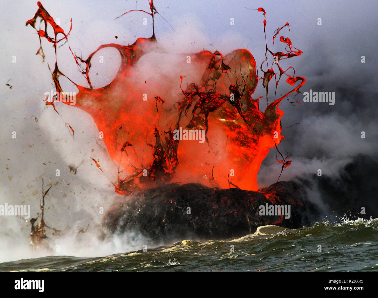 Big Island, Hawaii, USA. 25th Mar, 2006. Molten lava from the Kilauea Volcano explodes as it reaches the Pacific Ocean, the extreme temperature difference causing the dramatic reaction about Kalapana, Hawaii. Credit: L.E. Baskow/ZUMA Wire/Alamy Live News Stock Photo