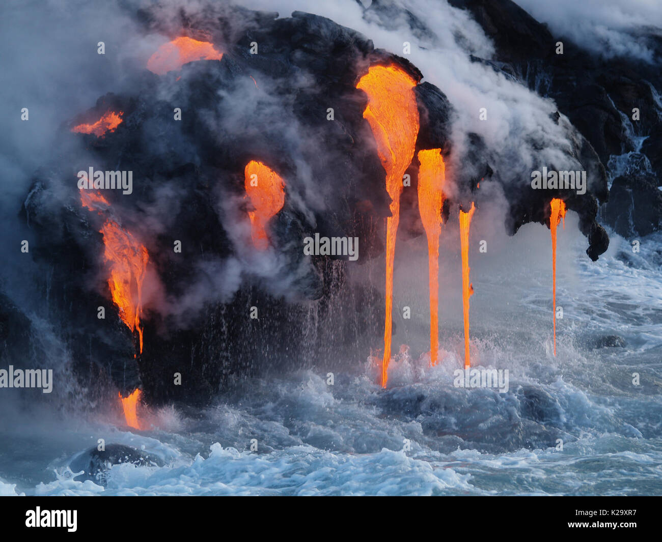 Big Island, Hawaii, USA. 22nd July, 2016. Molten lava from the Kilauea Volcano flows into the Pacific Ocean, the extreme temperature difference causing a dramatic reaction of bubbling and steam about Kalapana, Hawaii. Credit: L.E. Baskow/ZUMA Wire/Alamy Live News Stock Photo