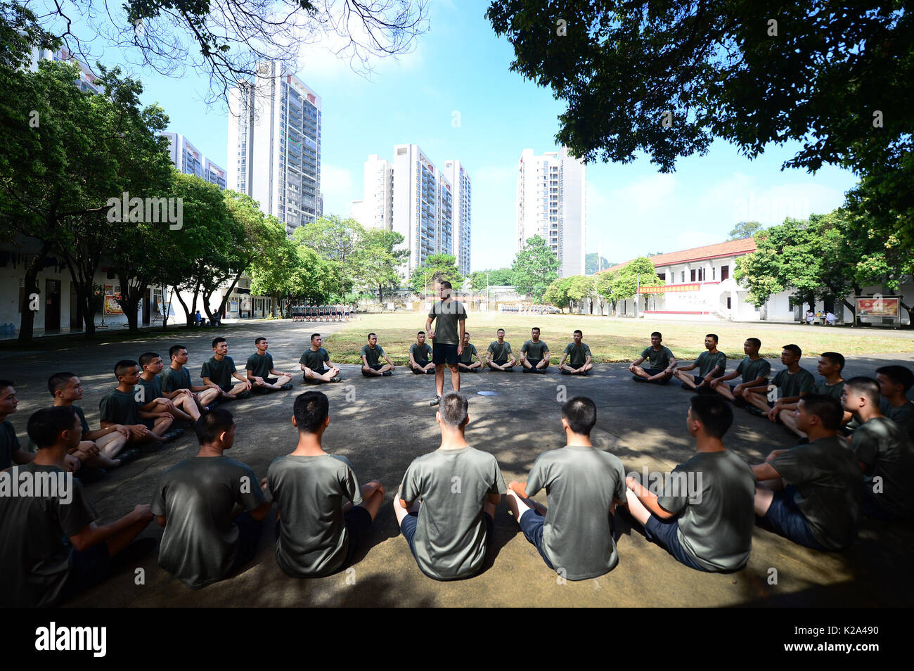Liuzhou, China. 30th Aug, 2017. Deng Feng (C) tells his former experience in the army during a training in Liuzhou, south China's Guangxi Zhuang Autonomous Region, Aug. 30, 2017. Deng, 24, who just graduated from Xingjian College of Science and Liberal Arts of Guangxi University, has signed for the army twice. When he was a freshman, Deng Feng was for the first time recruited as a soldier of Guangxi Frontier Corps of Chinese Armed Police and was on service for two years. Credit: Xinhua/Alamy Live News Stock Photo