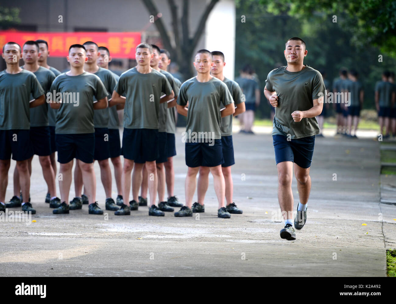 Liuzhou, China. 30th Aug, 2017. Deng Feng (R) takes part in a training for joining the army in Liuzhou, south China's Guangxi Zhuang Autonomous Region, Aug. 30, 2017. Deng, 24, who just graduated from Xingjian College of Science and Liberal Arts of Guangxi University, has signed for the army twice. When he was a freshman, Deng Feng was for the first time recruited as a soldier of Guangxi Frontier Corps of Chinese Armed Police and was on service for two years. Credit: Xinhua/Alamy Live News Stock Photo