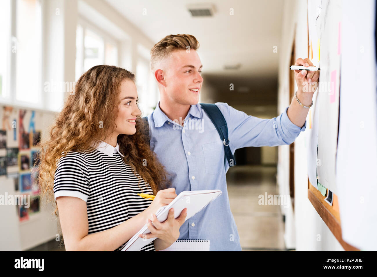 Attractive teenage student couple in high school hall. Stock Photo