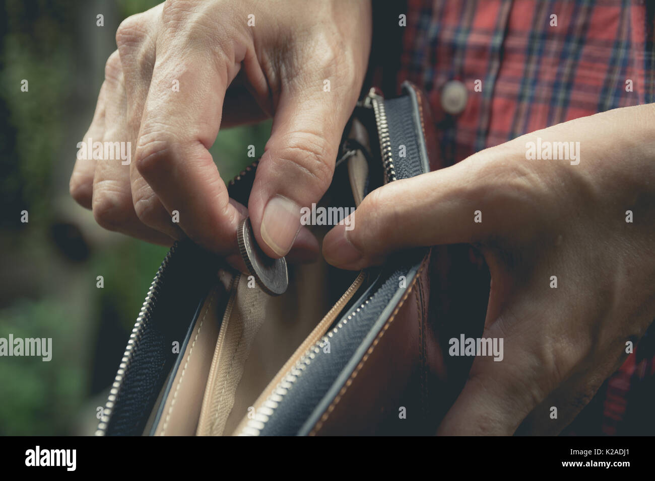 Close-up woman standing and holding money coin with wallet empty of ...