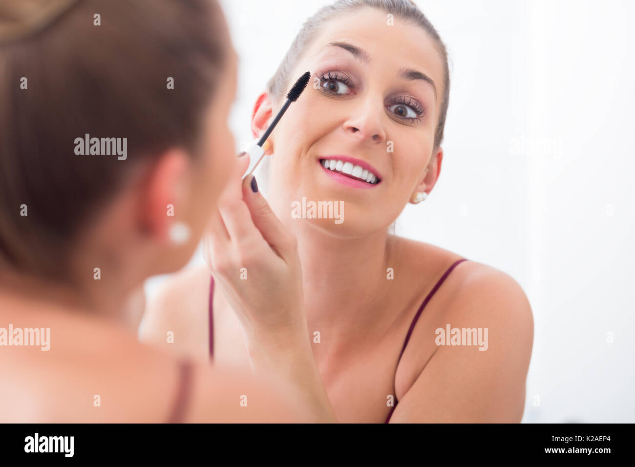 Woman using mascara on her eyelashes  Stock Photo