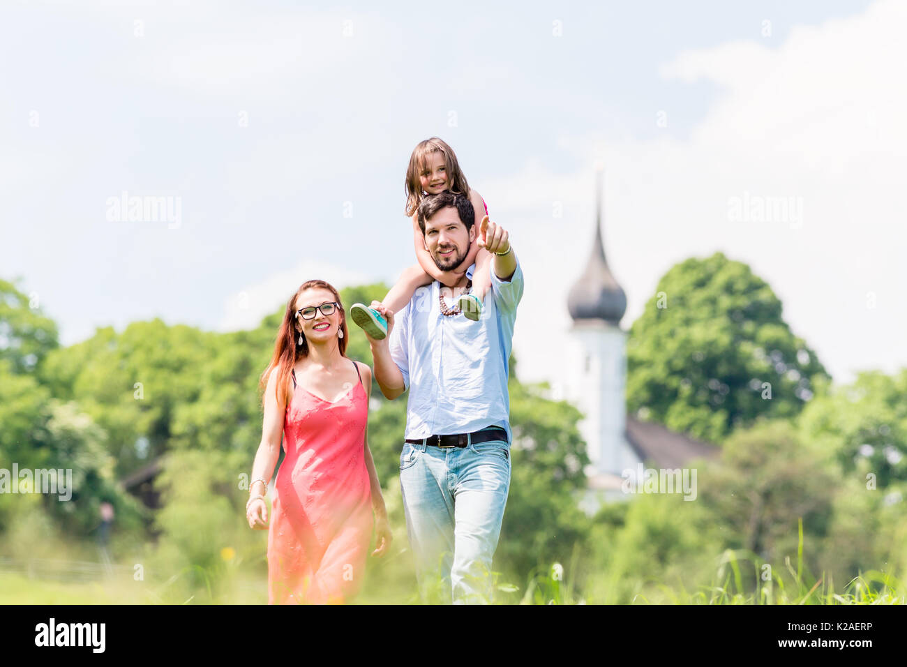 Family walking on meadow having walk Stock Photo